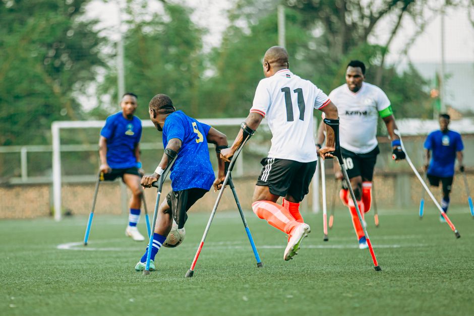 Dynamic outdoor amputee soccer match showcasing athletes' skills and teamwork.