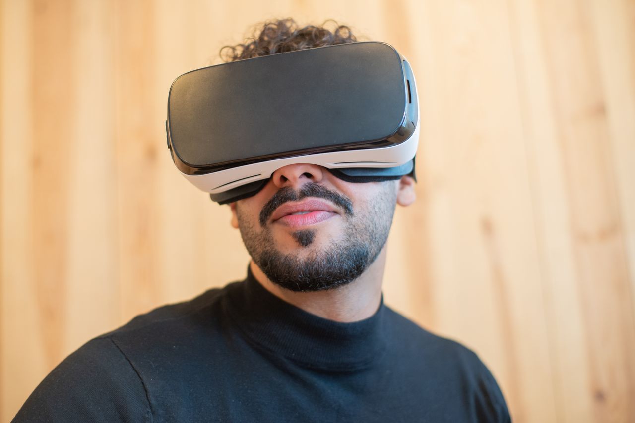 Close-up of a man wearing a virtual reality headset indoors, showcasing modern technology.